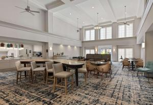 a large kitchen and dining room with tables and chairs at Homewood Suites by Hilton Lake Mary in Lake Mary