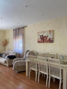 a living room with a table and chairs and a couch at Casa La Pradera Cañete in Cañete