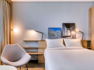 Cama ou camas em um quarto em Novotel BH Savassi