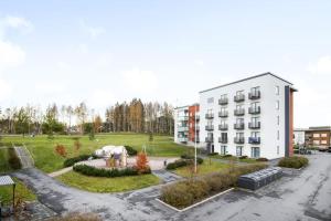 an apartment building with a park in front of it at Top Floor Tarutie in Kirkkonummi