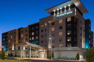 an exterior view of the hampton inn suites hotel at Hyatt House Orlando Airport in Orlando