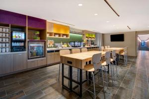 a restaurant with tables and chairs and a bar at Home2 Suites By Hilton Las Vegas North in Las Vegas