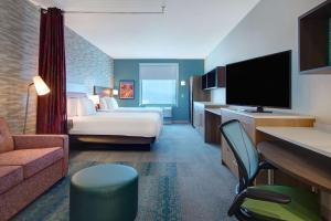 a hotel room with a bed and a television at Home2 Suites By Hilton Las Vegas North in Las Vegas