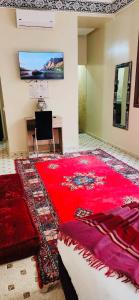 - une chambre avec un grand tapis rouge au sol dans l'établissement Riad Amazing, à Marrakech
