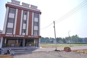a hotel square building on the corner of a street at HOTEL D SQUARE . in Shirdi