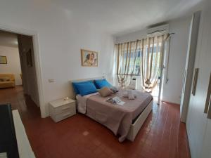 a bedroom with a large bed with blue pillows at Relax Fiorella in Ladispoli