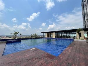 a swimming pool on the roof of a building at ONE BEDROOM APARTMENT POLLUX MEISTERSTADT BATAM CENTRE in Batam Center