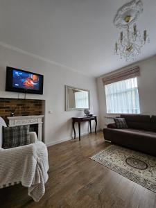 a living room with a couch and a fireplace at Vilnius City Walls apartment in Vilnius