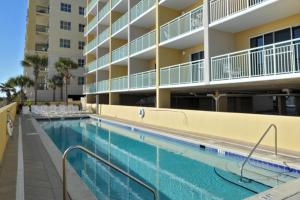 a swimming pool in front of a apartment building at Pelican Isle 418 in Fort Walton Beach
