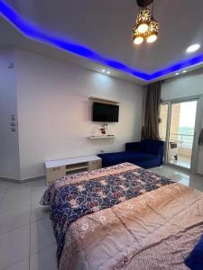 a bedroom with a bed and a blue ceiling at Casablanca Beach for families and couples only in Hurghada