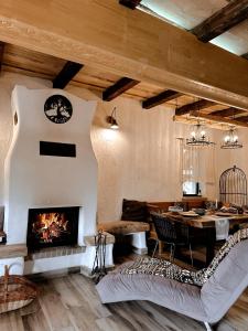 a living room with a fireplace and a table at Cuibul Braneanului in Bran