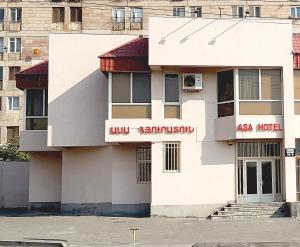 een wit gebouw met een Aziatisch hotelbord erop bij ASA Hotel in Jerevan