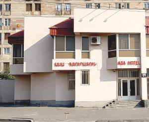 a white building with an asia hotel sign on it at ASA Hotel in Yerevan