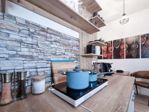 a kitchen with a stove with a stone wall at Alpha Apartments in Dortmund