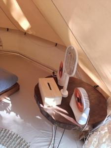 a table in a tent with a fan at Lainkalogos glamping in Rabia