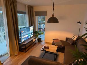 a living room with a couch and a flat screen tv at Feels Like Home in Gothenburg