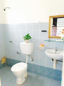 a bathroom with a toilet and a sink at D'Houzz in Sungai Petani