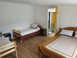 a room with three beds and a mirror at Posada de la Luna in Chile Chico