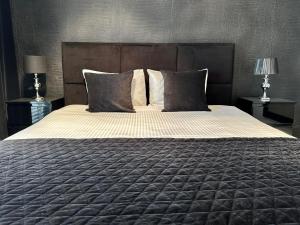 Posteľ alebo postele v izbe v ubytovaní LuxApart Kalisz