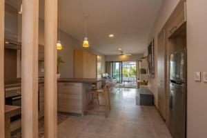 a kitchen with a island in the middle of a room at Wonderful Mont Choisy flat, huge lagoon pool in Mont Choisy