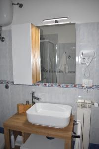 a bathroom with a white sink and a mirror at Casa Vacanze Oikia-Girasole in Naples