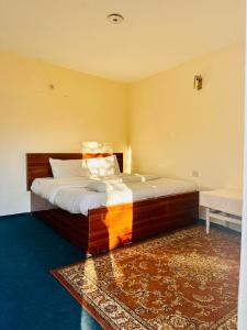 a bedroom with a large bed in a room at Backpackers Stories by Old Hunza Inn in Hunza