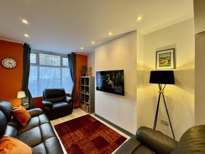 a living room with a couch and a chair at Crow Hill House - Tranquil Escape Hideaway in Cleethorpes