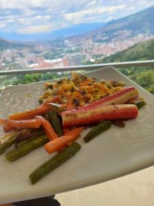 um prato de alimentos com legumes sobre uma mesa em Mansion 16 em Medellín