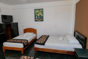 Postel nebo postele na pokoji v ubytování Hotel Las Palmas Cancun Centro