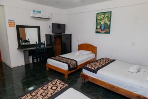 Postel nebo postele na pokoji v ubytování Hotel Las Palmas Cancun Centro