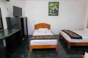 Postel nebo postele na pokoji v ubytování Hotel Las Palmas Cancun Centro
