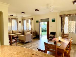a living room with a table and a couch at 3 Bedroom Luxury Villa-Sita in Diani in Kinondo