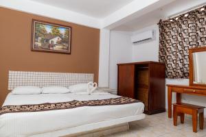 Postel nebo postele na pokoji v ubytování Hotel Las Palmas Cancun Centro