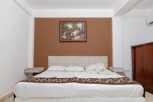 Postel nebo postele na pokoji v ubytování Hotel Las Palmas Cancun Centro