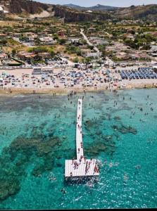 - une vue aérienne sur une plage avec des personnes dans l'eau dans l'établissement Casa vacanze Poma, à Custonaci