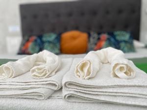 a pile of towels sitting on top of a bed at Superior Apartment Catania in Catania