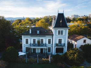 an aerial view of a white house with a turret at La Maison d'Igor in Morges