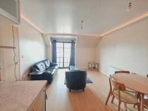 a living room with a couch and a table at Barking 1 bed flat With Parking in Barking