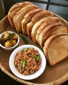 a plate of food with bread and a bowl of rice at The paulwood home cabin in Nuwara Eliya