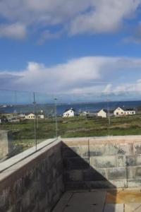 una vista da una finestra di un edificio con vista su un campo di Inis Mor, Aran Islands Luxury 5 bedroom with Seaviews 