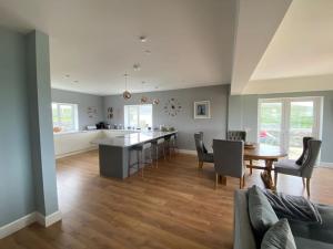 uma cozinha e sala de estar com mesa e cadeiras em Inis Mor, Aran Islands Luxury 5 bedroom with Seaviews 