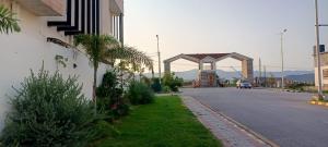 a street with a building on the side of a road at Haven Lodge, Islamabad in Islamabad