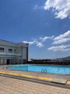 a large swimming pool in front of a building at Apartemen MTC Unit 626 in Manado