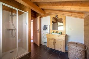 a bathroom with a shower and a sink at Chalet Talini in Les Gets +10 photos