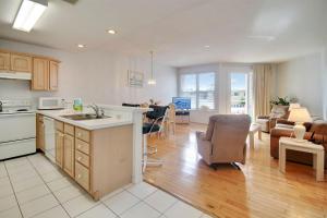 a kitchen and living room with a couch and a table at Amadeus 2 in St. Pete Beach