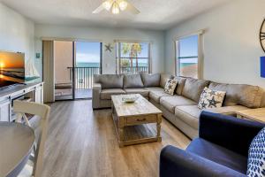 a living room with a couch and a table at Emerald Isle 204 in St. Pete Beach