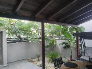 a patio with a table and chairs and a fence at Sweet cottage in Chanioporta in Heraklio Town