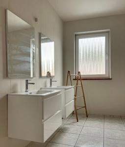 a bathroom with two sinks and a large mirror at Gohyssart 51b 2 Bruxelles-Charleroi-airport in Charleroi