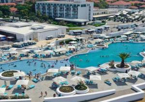 an overhead view of a large swimming pool with people in it at Seabreeze, Lighthouse, Baku, Azerbaijan in Baku