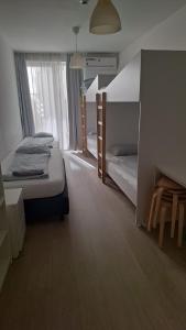 a bedroom with two bunk beds and a window at Betariel Apartments S22 in Vienna